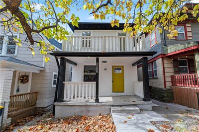 Townhome / multi-family property featuring a porch and a balcony | Image 2