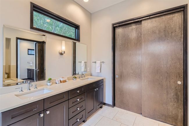 Bathroom featuring double vanity, a sink, and tile patterned floors | Image 8