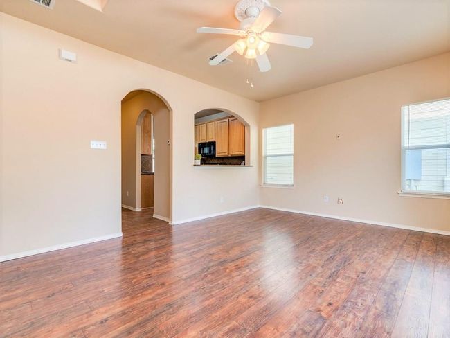 The living room is bright and spacious with room for a dining area. | Image 10