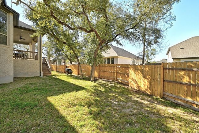 Enjoy the peaceful surroundings of the backyard, offering a serene space for relaxation and outdoor play. | Image 27