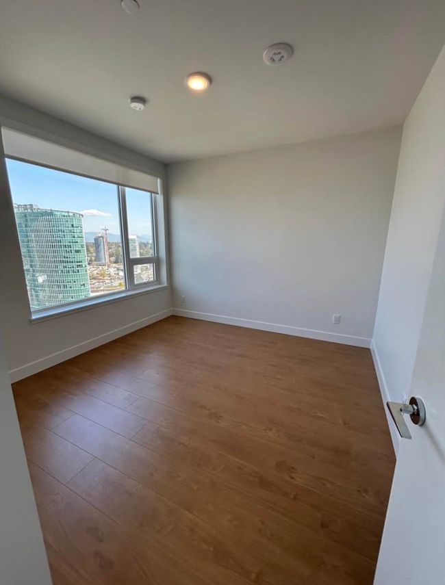Empty room featuring baseboards and dark wood-type flooring | Image 5