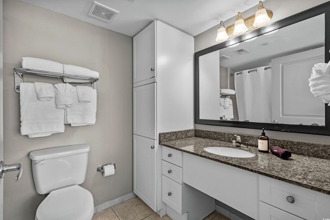 Bathroom with tile patterned flooring, vanity, visible vents, and toilet | Image 20