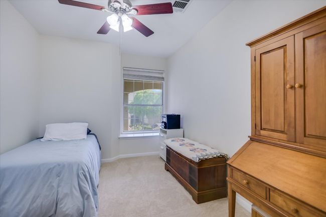 Bedroom with light carpet and a ceiling fan | Image 13
