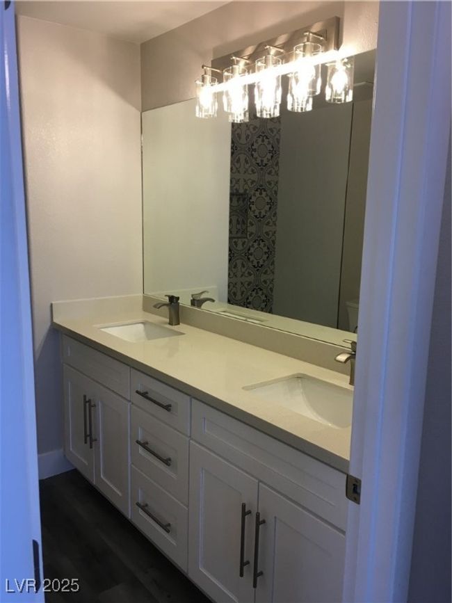 Bathroom with double vanity, wood finished floors, and a sink | Image 21