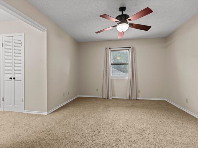 Bedroom 3 Carpeted spare room featuring ceiling fan, a textured ceiling, and baseboards | Image 32