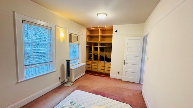 Unfurnished bedroom with carpet flooring and radiator heating unit | Image 6