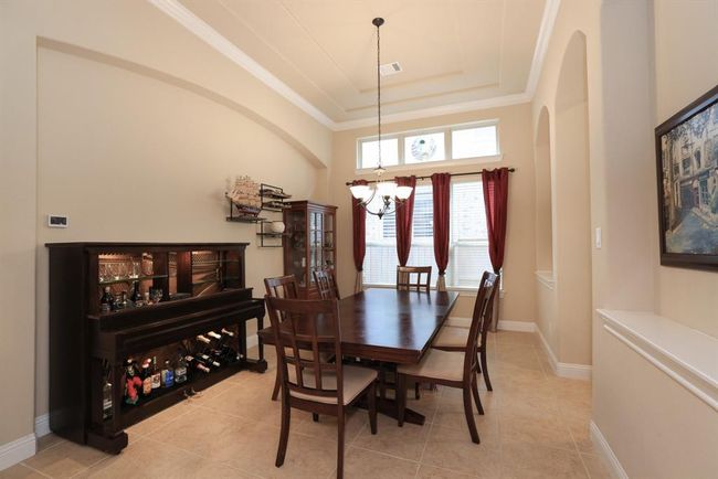 Formal dining with kitchen access and double recessed niches for pictures and display decor. | Image 11