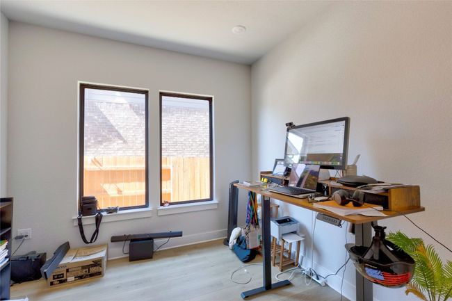 Office space with baseboards and wood finished floors | Image 7