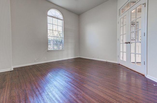 Unfurnished room with french doors, dark wood-style flooring, and baseboards | Image 8