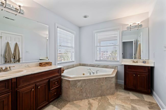 Full bath with two vanities, a tub with jets, and marble finish floors | Image 24