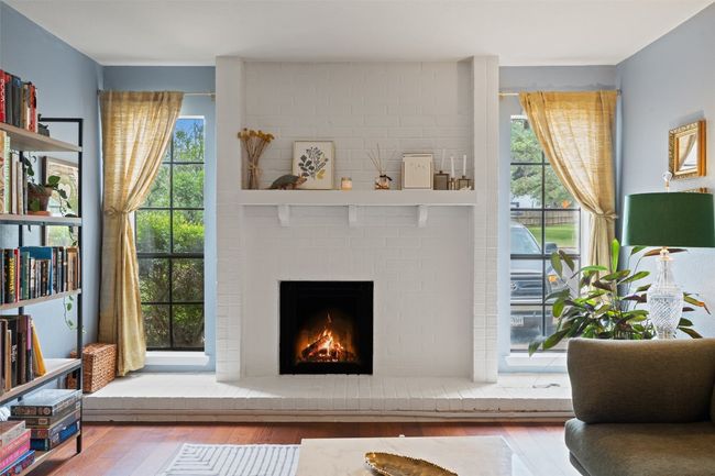 Sitting room featuring a brick fireplace, a wealth of natural light, and hardwood / wood-style floors | Image 10