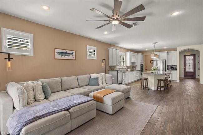 Living room with ceiling fan, sink, and dark hardwood / wood-style floors | Image 6