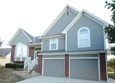 View of front of property with a garage | Image 1