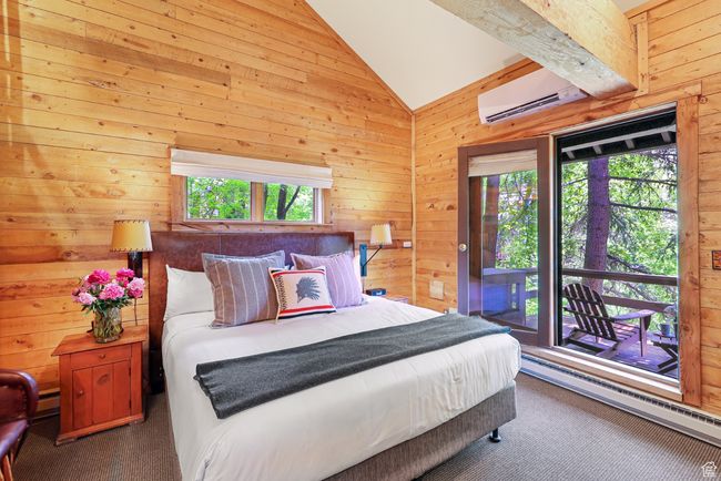 Master bedroom King bed, wall mounted AC and heat, lofted ceiling, and access to exterior deck | Image 27