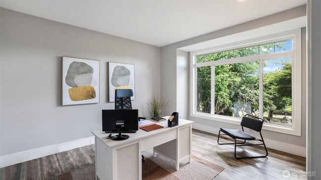 Let your creativity shine in this flexible downstairs front room with beautiful hardwood floors, tons of natural light, and plenty of space to make it your own—whether that’s a home office, play space, or extra bedroom. Built-in closets offer convenient storage for any personal needs! | Image 6