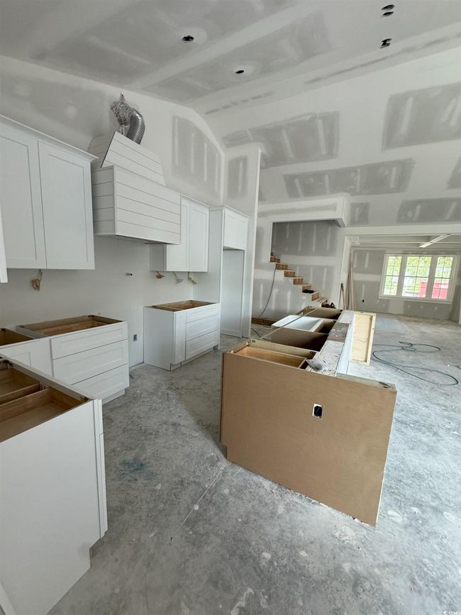 Kitchen with white cabinets and vaulted ceiling | Image 22