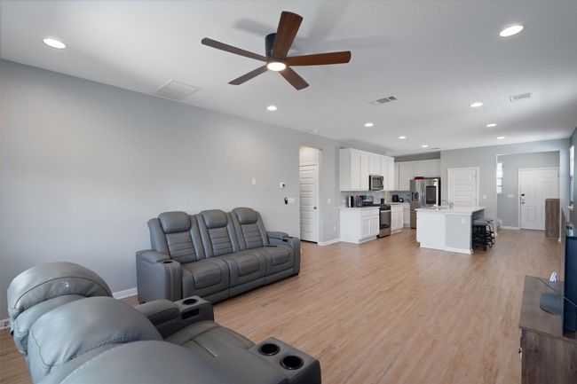Living area featuring ceiling fan, light wood finished floors, and recessed lighting | Image 10