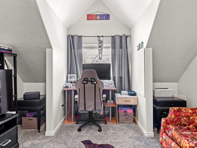 Home office with carpet floors and lofted ceiling | Image 23