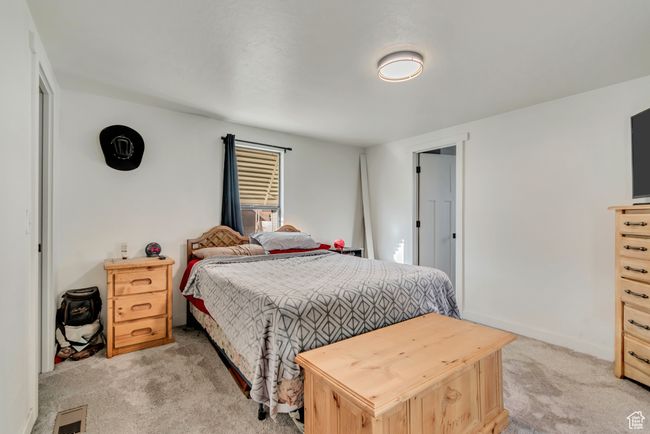 Bedroom with light carpet, baseboards, and visible vents | Image 12