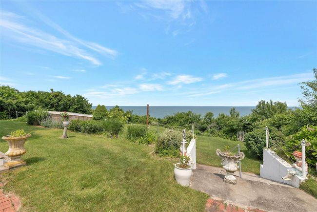 View of grassy yard with a water view and a patio area | Image 23