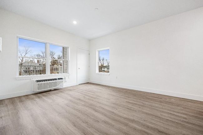 Spare room with a wall mounted AC, wood finished floors, baseboards, and recessed lighting | Image 20