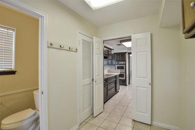 View from the laundry room into the kitchen. | Image 11