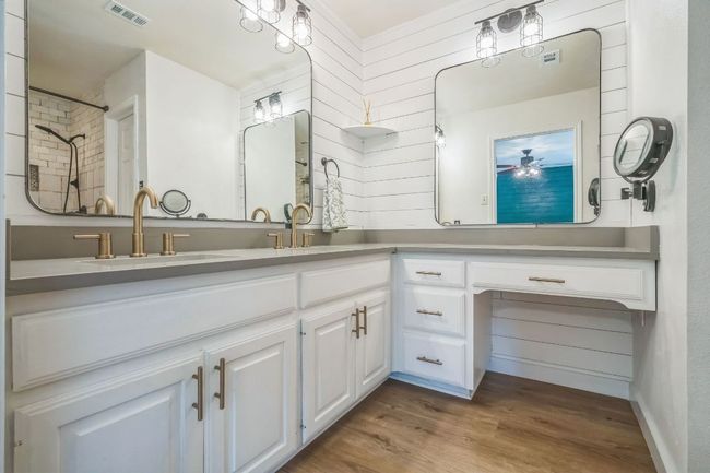 Full bathroom featuring double vanity and wood finished floors | Image 19