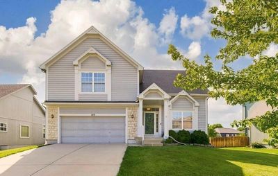 View of front facade with a garage and a front lawn | Image 1