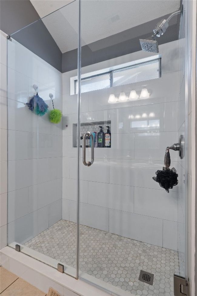 Bathroom featuring a stall shower and tile patterned flooring | Image 16