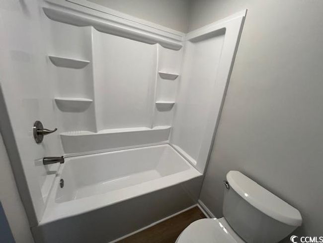 Bathroom featuring toilet and shower / bathing tub combination | Image 20