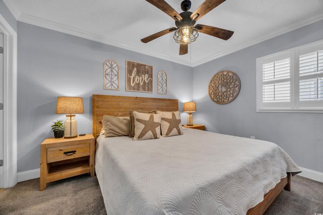 Bedroom featuring carpet floors, baseboards, ornamental molding, and ceiling fan | Image 5