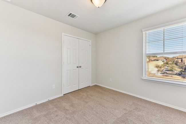 Unfurnished bedroom with a closet, carpet floors, visible vents, and baseboards | Image 23