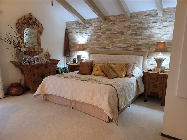 Bedroom with vaulted ceiling with beams and carpet | Image 27