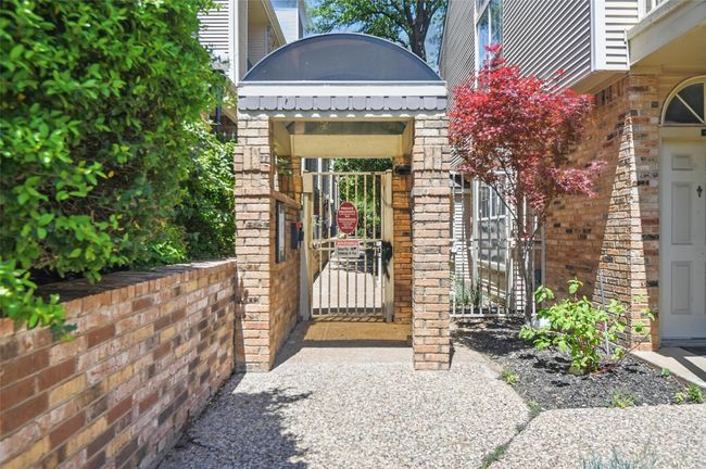 Doorway to property with a gate and brick siding | Image 27