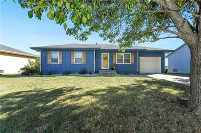 Ranch-style house featuring a front yard and a garage | Image 2