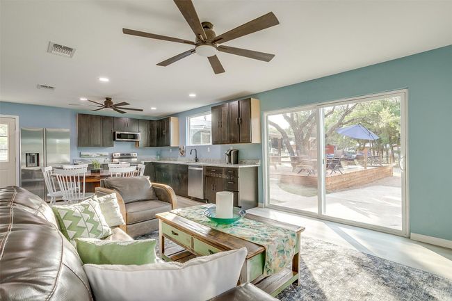 Living area with baseboards, a ceiling fan, visible vents, and recessed lighting | Image 19