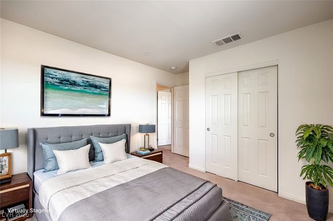 Bedroom with light colored carpet, a closet, visible vents, and baseboards **VIRTUALLY STAGED** | Image 7
