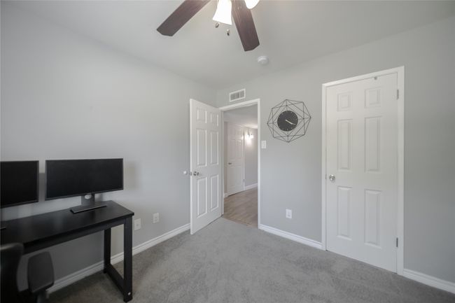 Office with ceiling fan and carpet | Image 21