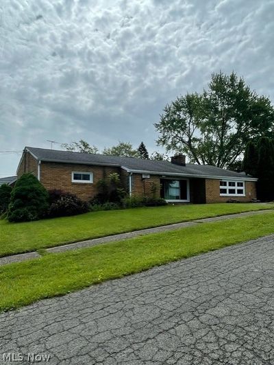 Ranch-style home featuring a front lawn | Image 1