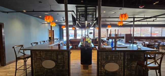 Bar featuring baseboards and pendant lighting | Image 9
