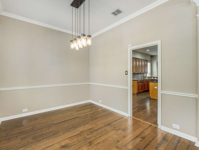 Empty room featuring dark wood-style floors and crown molding | Image 6