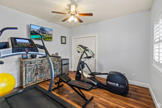 Workout area with hardwood / wood-style floors and ceiling fan | Image 72