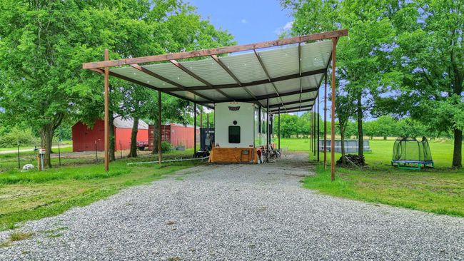 View of car parking featuring driveway and a carport | Image 4