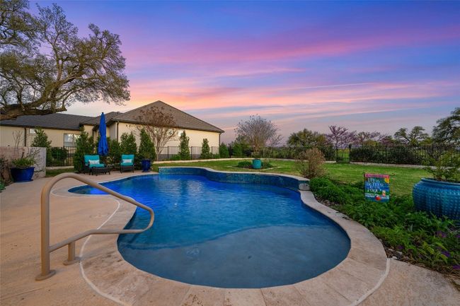 Pool at dusk featuring colored lights. | Image 26
