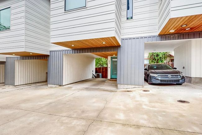 Garage with a carport and driveway | Image 6