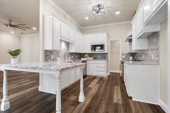 The kitchen has lots of storage, and a counter extension that serves as extra counter space or seating. | Image 14