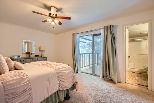 Bedroom with access to exterior, light colored carpet, ensuite bathroom, a ceiling fan, and crown molding | Image 14