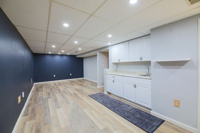 Family room located in the basement with mini-kitchen/wet bar area perfect for your big screen television and host the next Lions game watch party! | Image 18