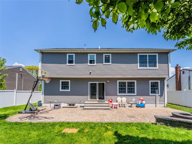 Rear view of house featuring a fire pit, a patio, and entry steps | Image 29