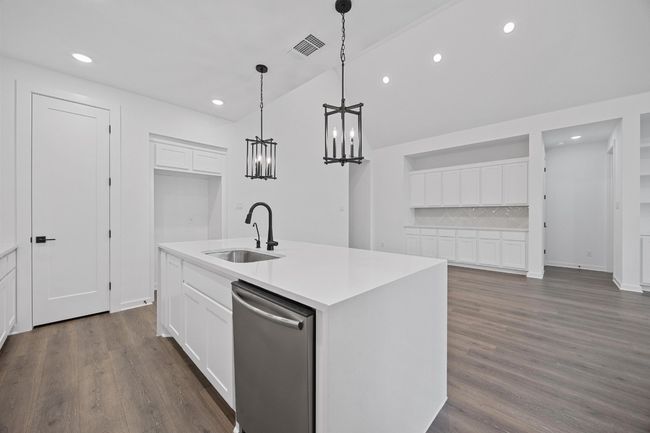 Kitchen with dishwasher, tasteful backsplash, a kitchen island with sink, recessed lighting, and white cabinetry | Image 7
